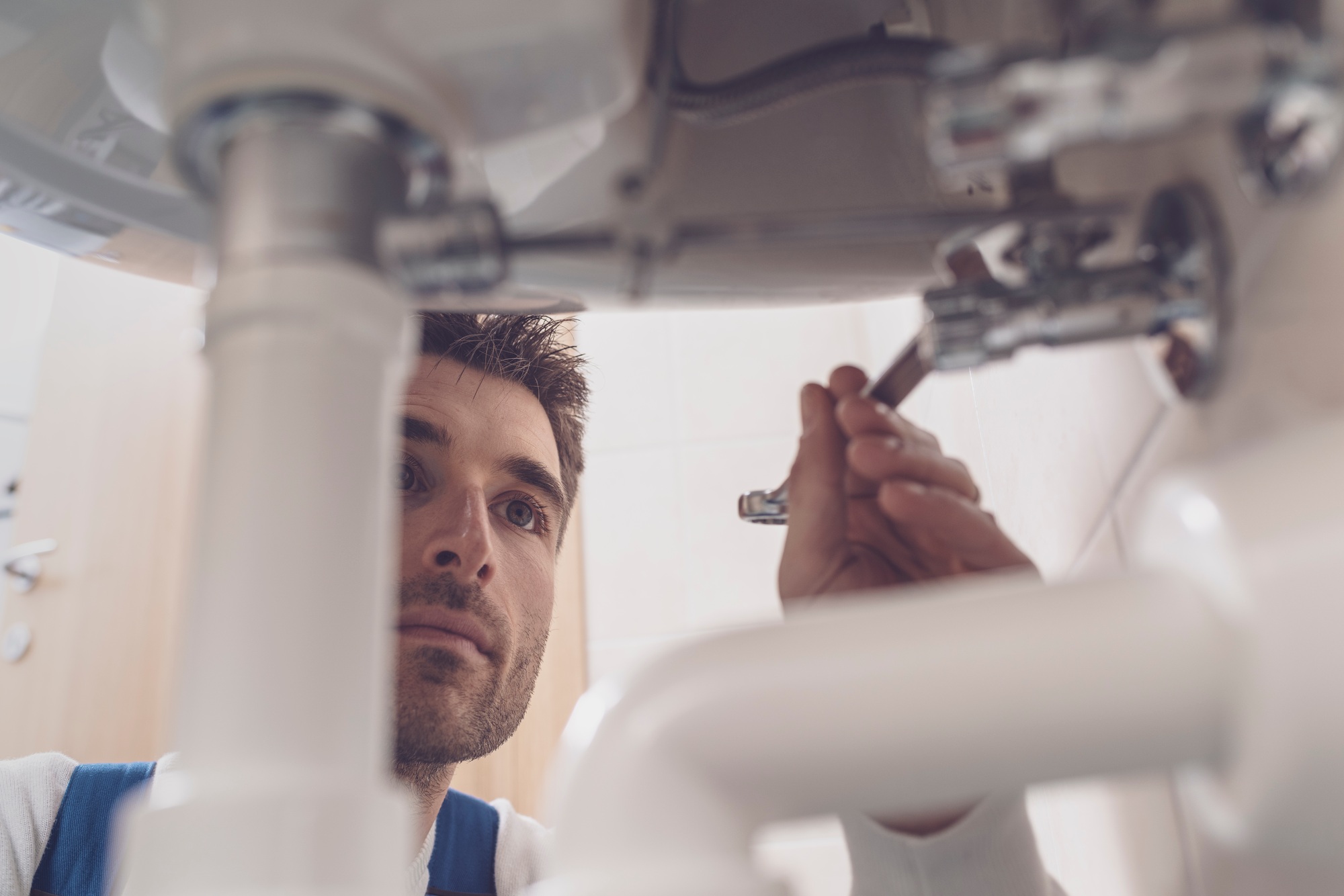 Plumber fixing a sink at home